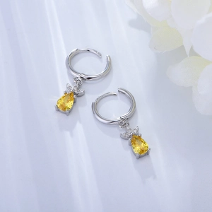 Detail of S925 sterling silver hoop earrings with yellow zircon pineapple pendants