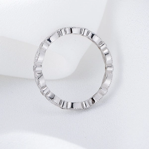 Macro detail of S925 sterling silver eternity ring with wavy pavé diamond setting