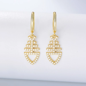 Macro shot of gold fishbone earrings with sparkling pavé cubic zirconia inlay detail