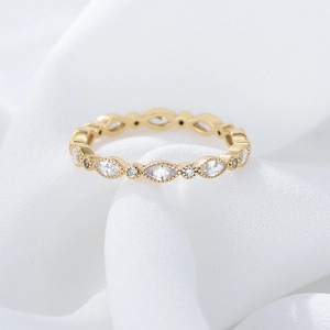 Macro shot of s925 silver gold-plated ring with milgrain edges and marquise stones