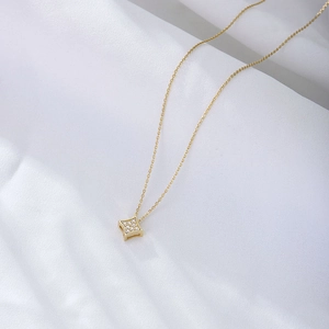 Elegant gold square star necklace with pavé zircon pendant on white silk background