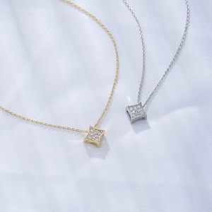 Elegant geometric square zircon pendant necklaces in gold and silver on blue silk fabric