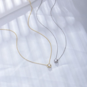 Detailed view of 925 silver and gold necklaces with round cubic zirconia pendants