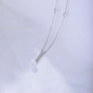 Detail of S925 sterling silver necklace featuring a pearl pendant and zircon accents