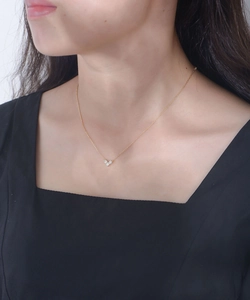 Close-up of heart pendant necklace with white zircons worn on model's neck
