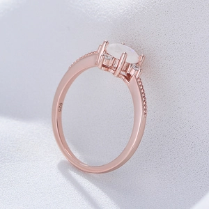 Rose gold 925 silver ring featuring an oval moonstone and side diamond accents