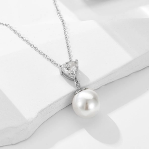 Minimalist S925 silver necklace featuring a heart zircon and white pearl on white stone