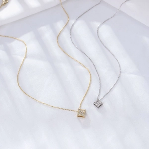 Close-up of square geometric star pendants with zircon inlay in gold and silver finish
