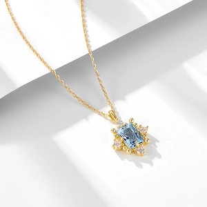 Elegant s925 silver necklace with sky blue topaz pendant and gold snowflake details