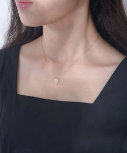 Detail of s925 silver gold-plated necklace with round moonstone and crystal pendant