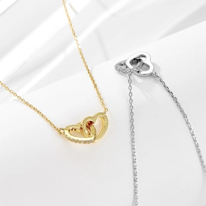 Interlocking double heart necklace in gold and silver with sparkling cubic zirconia accents