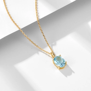 Minimalist sky blue topaz sterling silver necklace with oval cut pendant on gold chain
