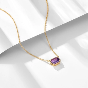 Rectangle amethyst pendant necklace in gold finish on a minimalist geometric background