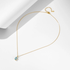 Elegant 925 sterling silver gold necklace featuring a sky blue oval topaz pendant