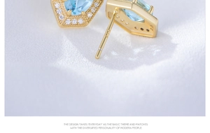 Macro detail of hexagonal blue topaz stud earrings with S925 sterling silver stamp