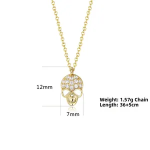 Detailed view of gold skull pendant with white zircons on a 36+5cm adjustable chain