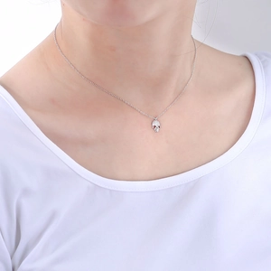Close-up of S925 sterling silver skull pendant necklace with pavé diamonds on model