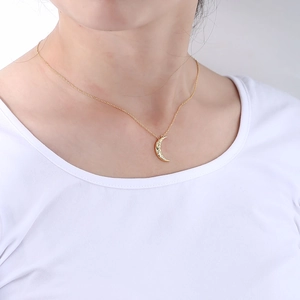 Minimalist S925 silver crescent moon necklace with sparkling crystals on a gold chain