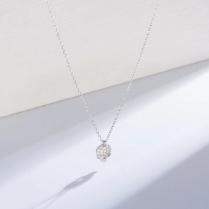 Macro detail of S925 silver skull necklace pendant with sparkling paved crystals
