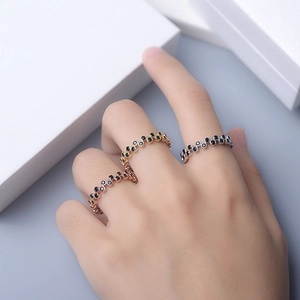 Set of stacked sterling silver wave rings with black zircon stones in three colors