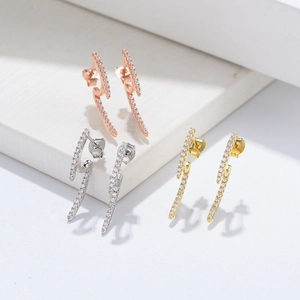 Macro detail of lightning bolt silver earrings set with pave cubic zirconia stones