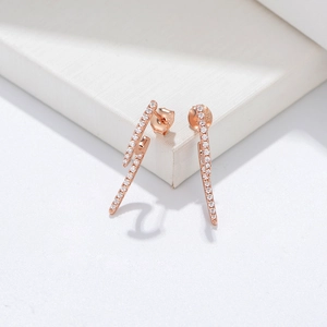 Detailed view of rose gold lightning bolt earrings with micro-pave cubic zirconia crystals