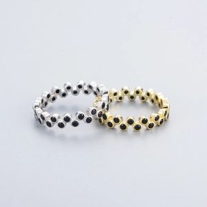 Minimalist sterling silver rings with alternating black zircon settings in gold and silver