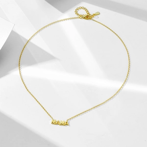 Macro detail of gold plated S925 sterling silver MAMA letter pendant and adjustable chain