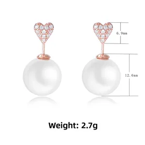 Détail de boucles d'oreilles cœur perle en or rose avec diamants et dimensions précises
