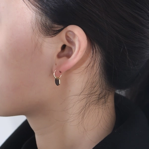Chic S925 silver hoop earrings with irregular black zircon pendant on model