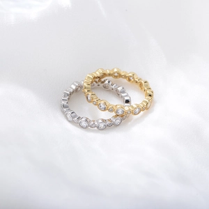 Detail of s925 silver geometric rings in gold and silver finish with pavé set zircon stones