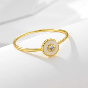 Elegant s925 silver gold ring with white enamel and a sparkling round cubic zirconia