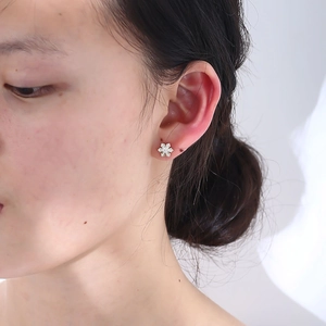 Elegant S925 silver snowflake stud earrings with sparkling cubic zirconia on model
