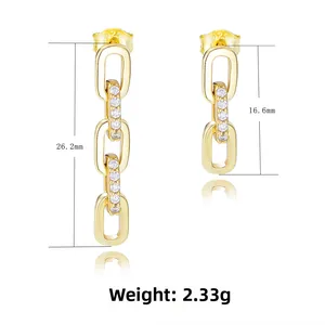 Detail of asymmetrical S925 silver gold chain earrings with sparkling zircon inlay