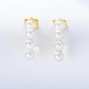 Elegant gold drop earrings featuring four white pearls in vertical alignment on white background