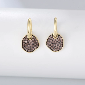 Macro shot of S925 sterling silver hoop earrings with irregular brown zircon stones