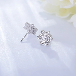 Macro shot of S925 silver snowflake stud earrings with sparkling cubic zirconia inlay