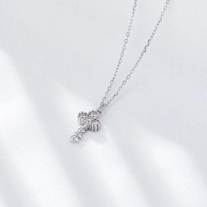 Elegant S925 sterling silver key pendant necklace with sparkling pavé stones on white silk