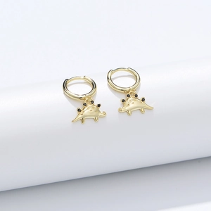 Detailed close-up of a gold dinosaur charm hoop earring with black zircon back spikes