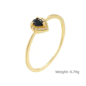 Detailed view of gold teardrop ring with black zircon, weight 0.79g for size reference
