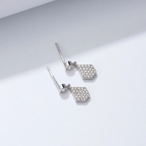 Macro detail of S925 silver pentagon shield earrings with micro-pave cubic zirconia