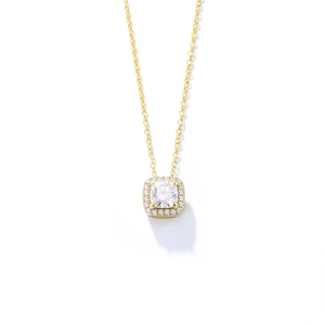 Macro detail of gold square halo pendant with centered zircon and delicate chain