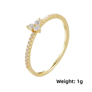 Detail of thin 925 sterling silver gold ring with micro-set zircon flowers weight 1g