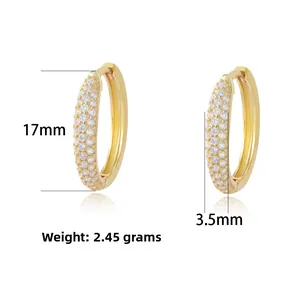 Macro shot of gold hoop earrings with dimensions 17mm by 3.5mm and zircon inlay