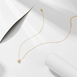 Detailed macro view of the gold teardrop pendant with micro-pave cubic zirconia stones