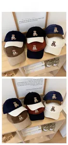 Close-up of retro corduroy baseball cap featuring detailed bear embroidery and texture