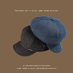 Washed denim octagonal newsboy hats in black and dark blue with metal emblem detail