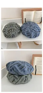 Detail of vintage striped denim beret hats in gray and indigo with multi-panel stitching