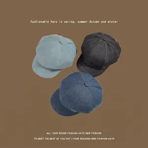 Classic washed denim newsboy octagonal hats in blue and grey black on a brown background