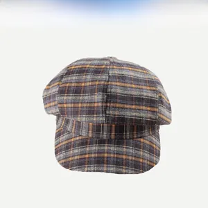 Close-up of retro plaid pattern fabric on the newsboy hat with textured weave detail
